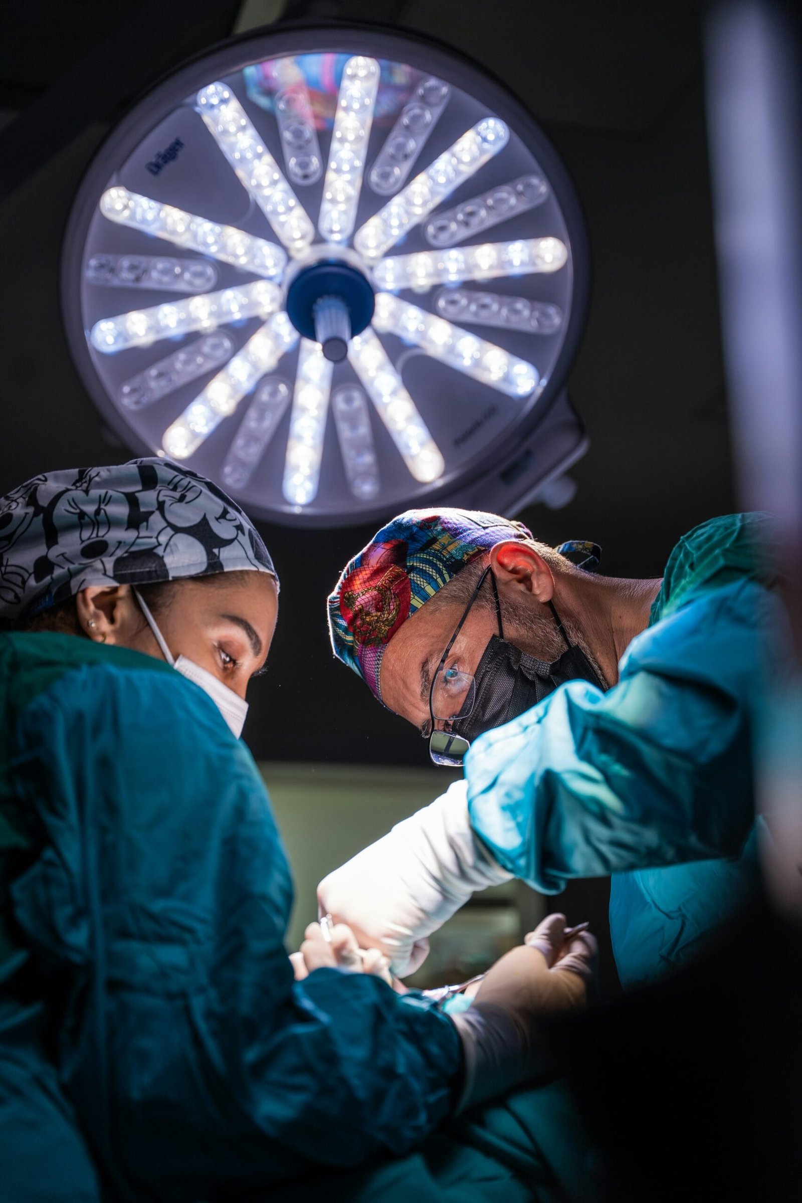 two surgeons performing surgery on a patient in a hospital